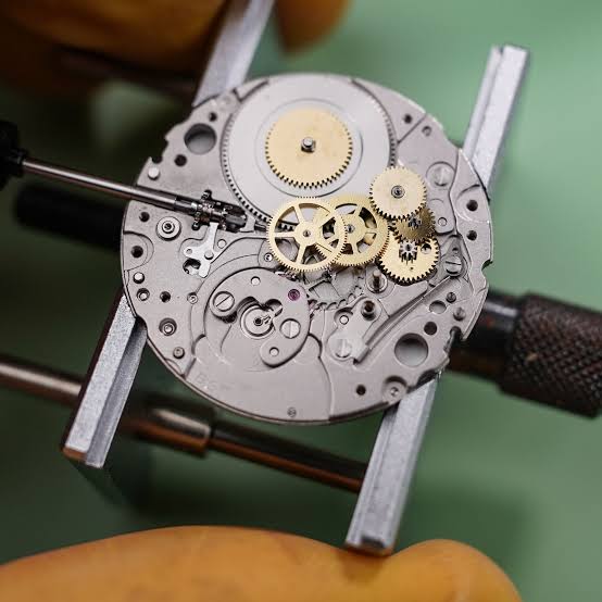 TimeRepair watchmaker servicing a mechanical watch movement