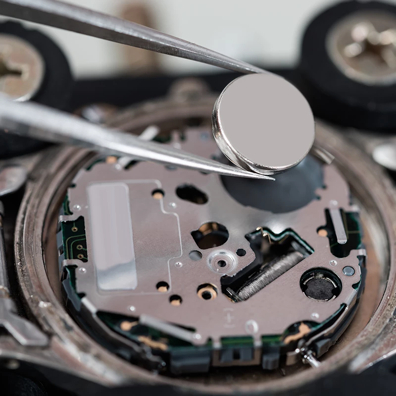 TimeRepair specialist performing a careful watch battery replacement