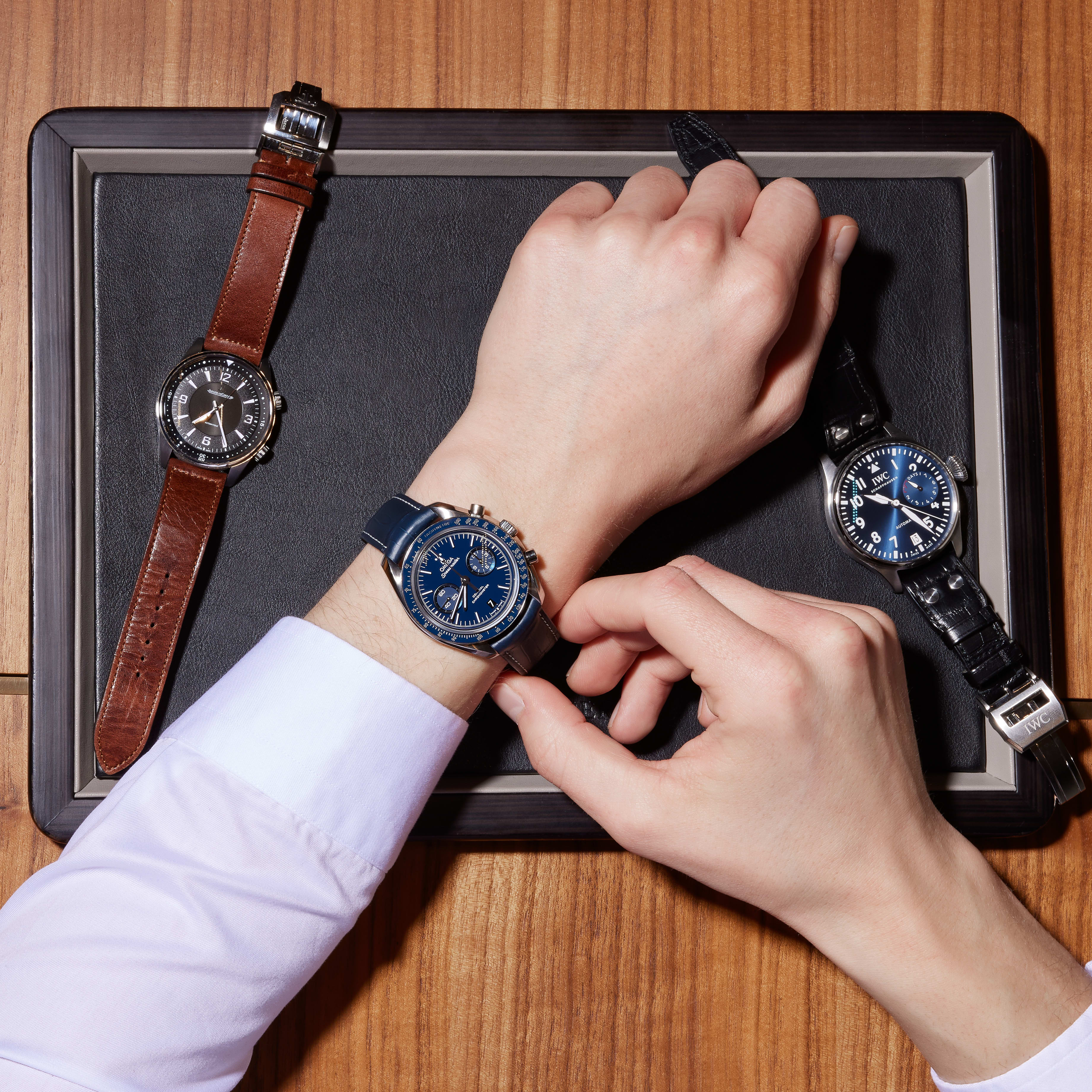 TimeRepair specialist carefully inspecting a watch case and bracelet