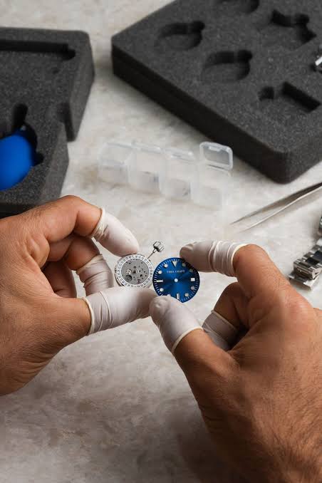 TimeRepair watchmaker carefully servicing a timepiece with precision tools